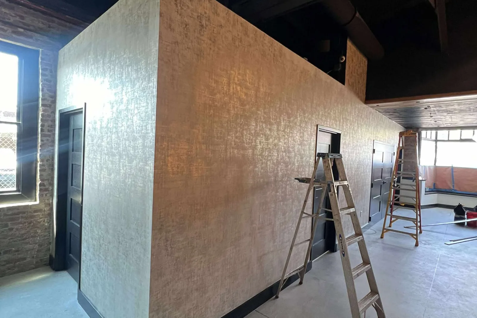 Rafael installing wallpaper in a residential room